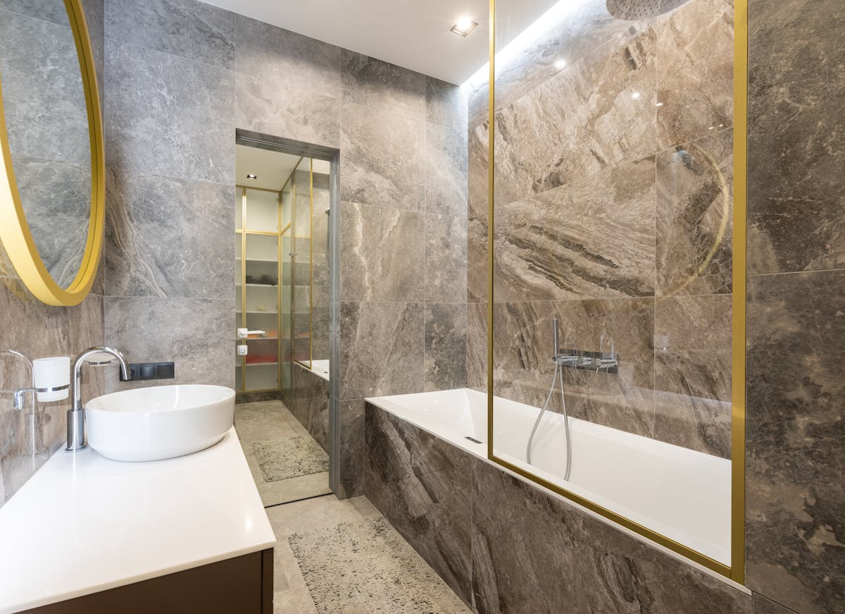 Modern bathroom sink with a chrome faucet beside a bathtub